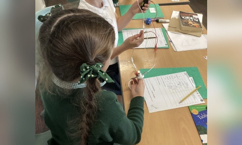 A pupil testing a circuit in an electricity lesson