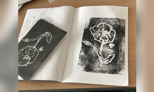 A poppy print next to its printing block