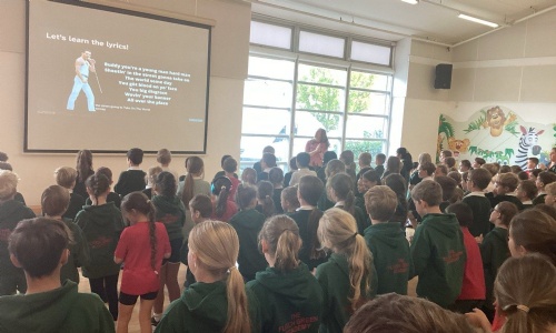 Pupils in the hall learning lyrics during the Freddie Mercury music assembly