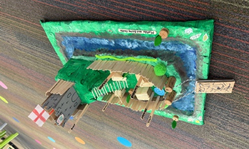 A model motte and bailey castle with a moat, made at home by a Year 2 pupil